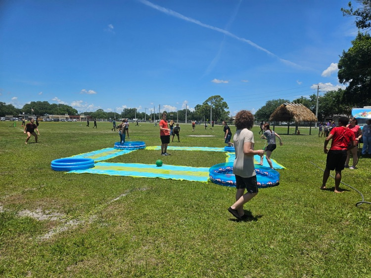 students playing on water slide