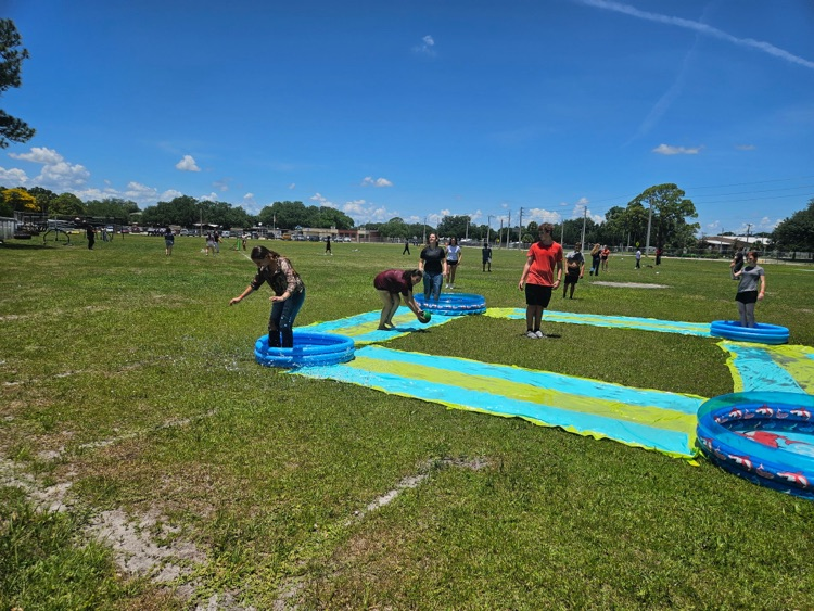 students playing on water slide