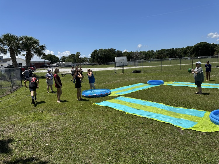 students playing on water slide