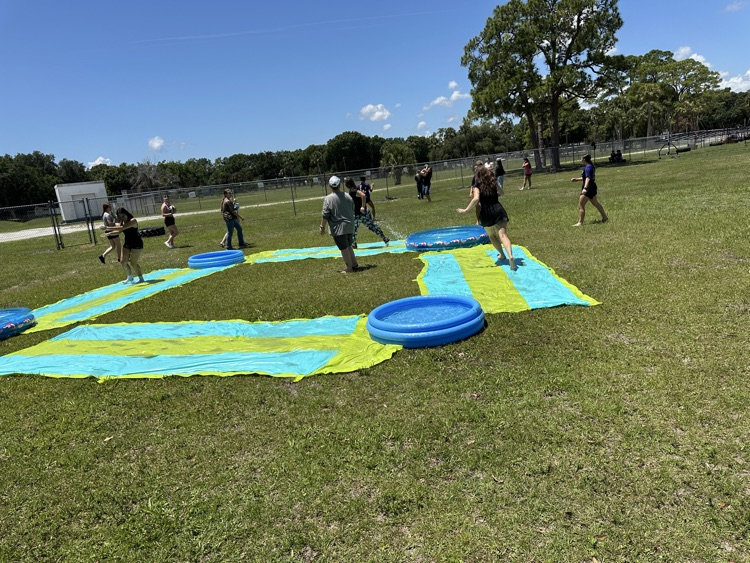 students playing on water slide