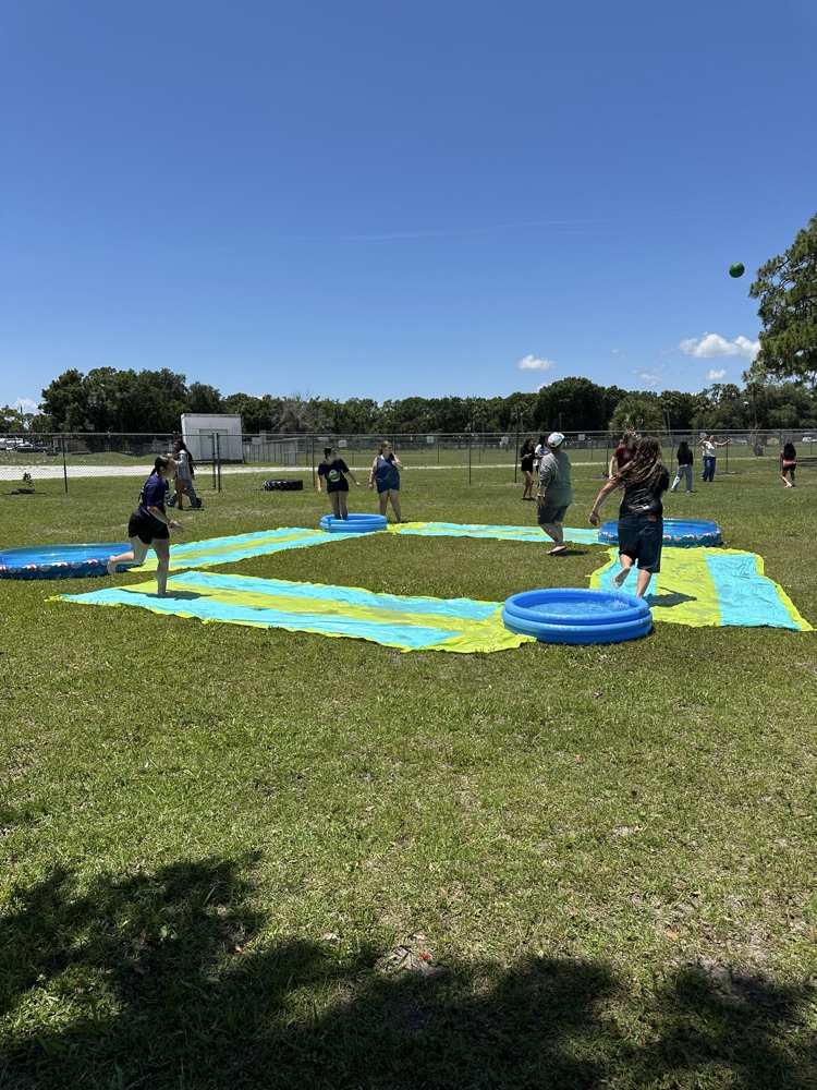 students playing on water slide
