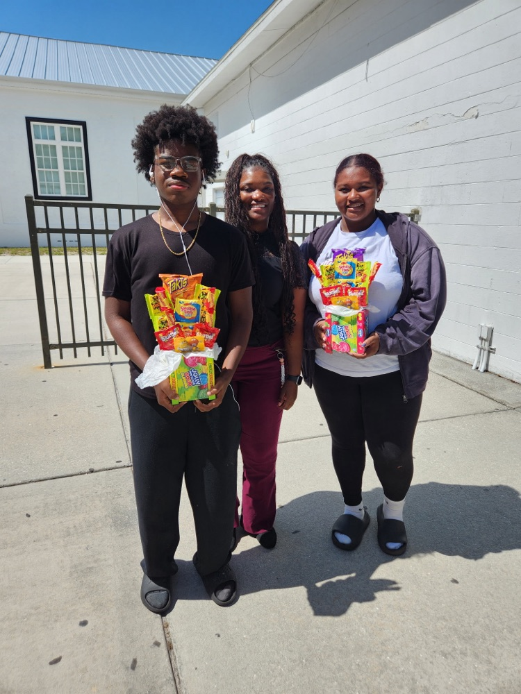 two students and guidance counselor outside