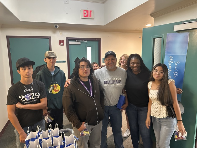 students with teacher getting goody bags
