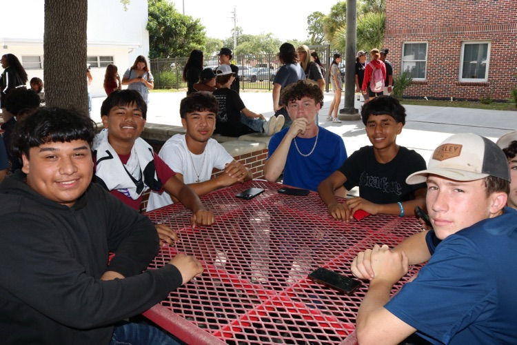 group of boys sitting in courtyard
