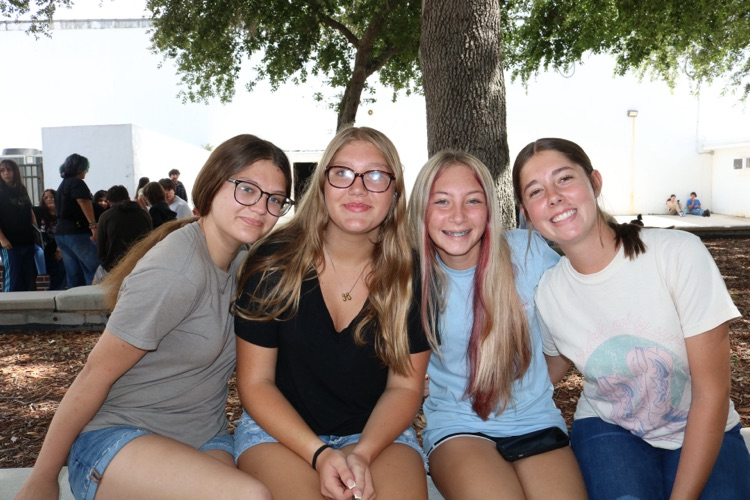 group of girls sitting in courtyard 