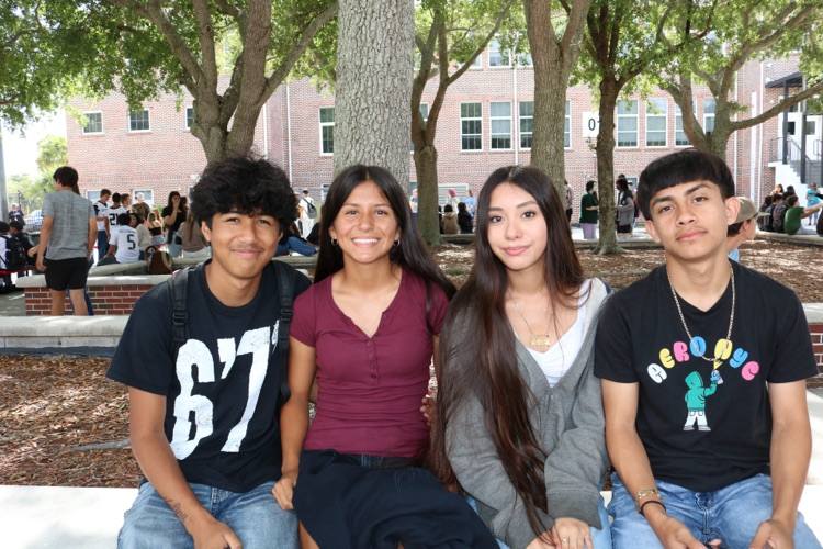 group of students sitting in courtyard