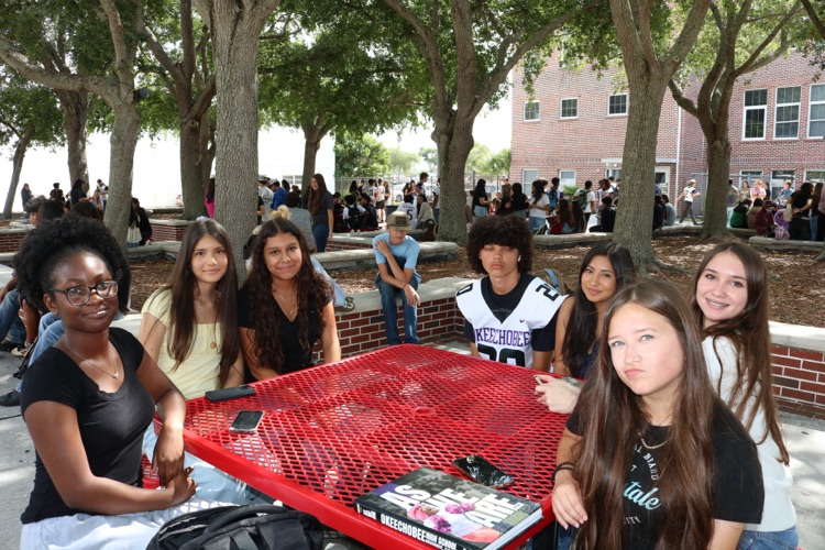 group of students sitting in courtyard