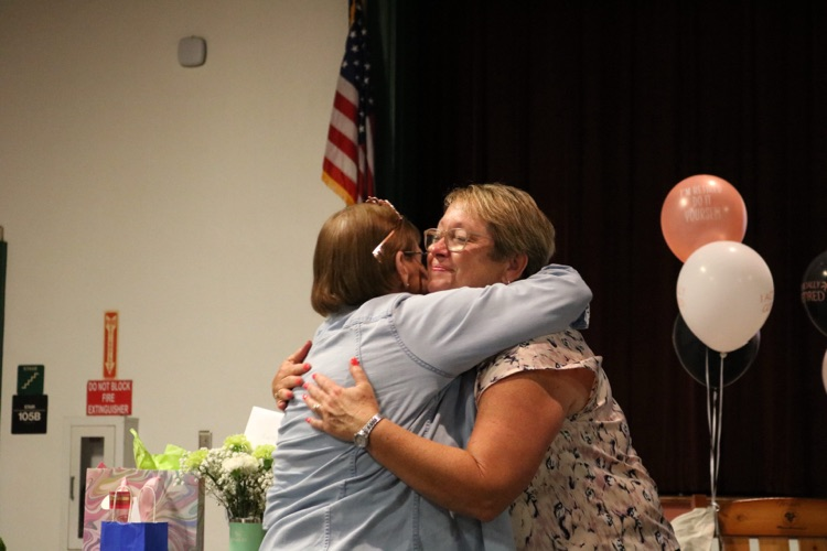 principal hugging school member 