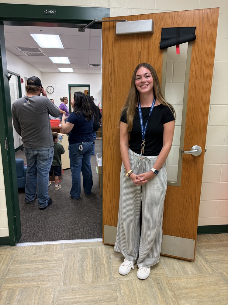 teacher at open house by the door