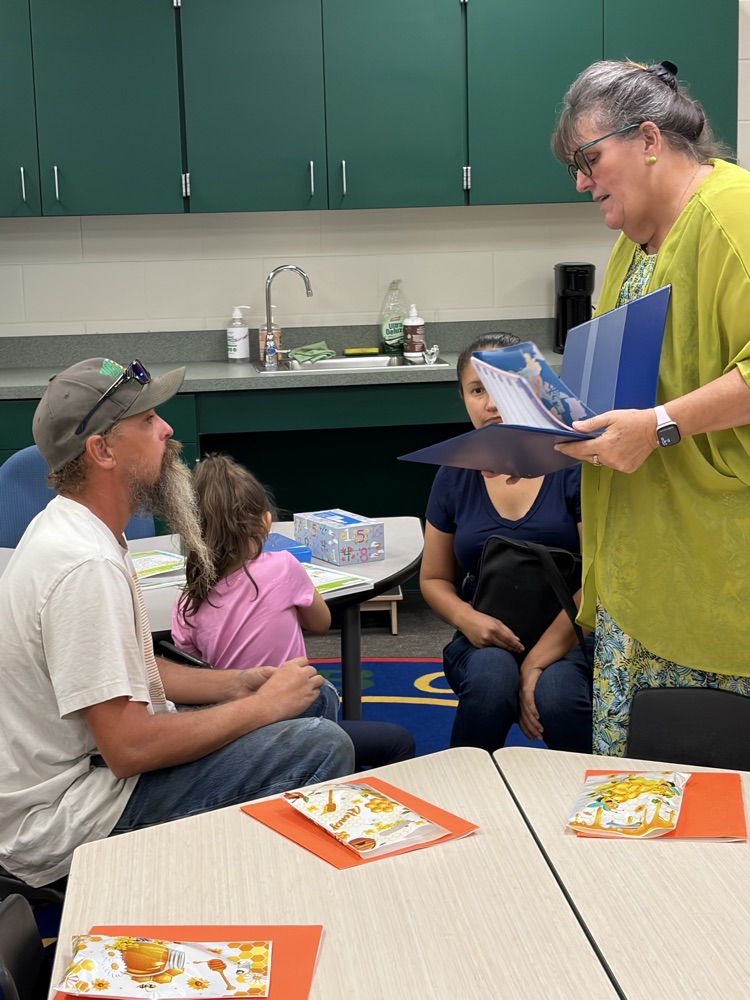 parents at open house speaking to teacher