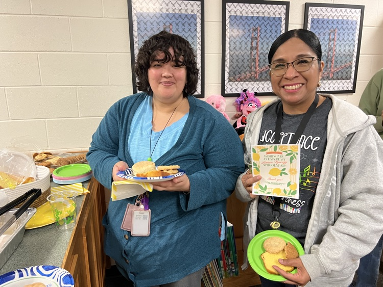 two teachers getting food at meeting