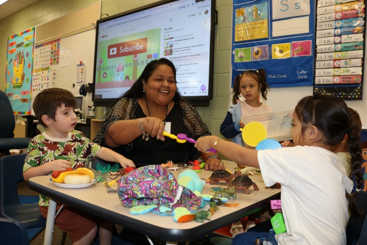 teacher helping small group