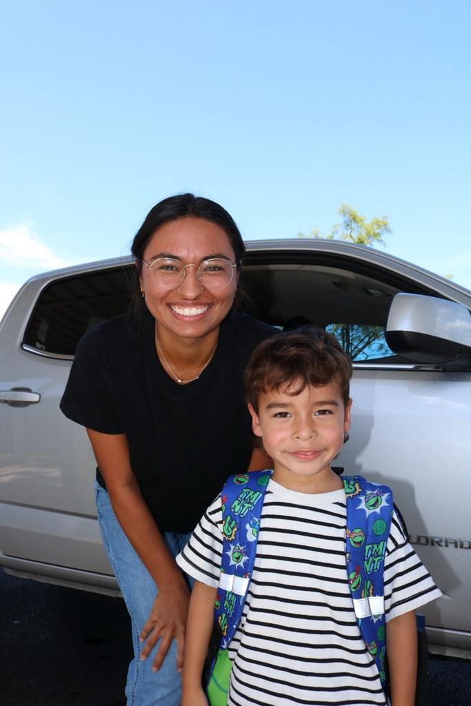 student and mom by car at drop off
