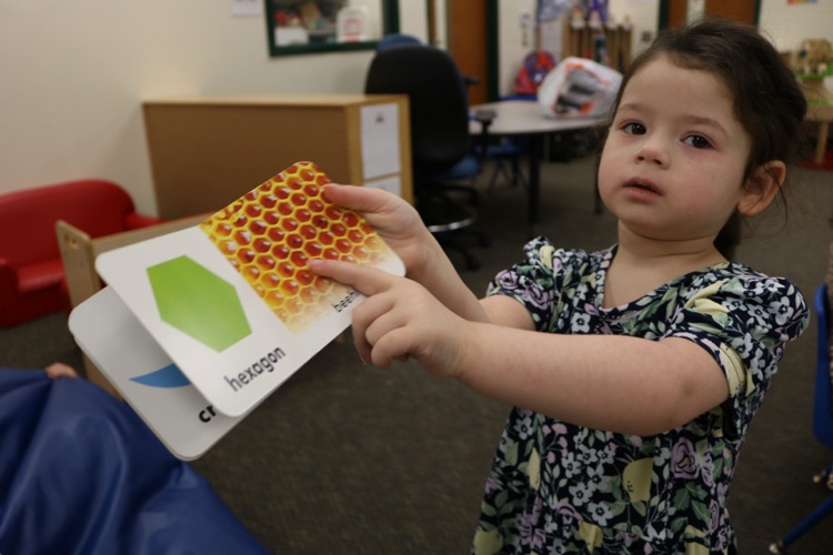 vpk student showing a book