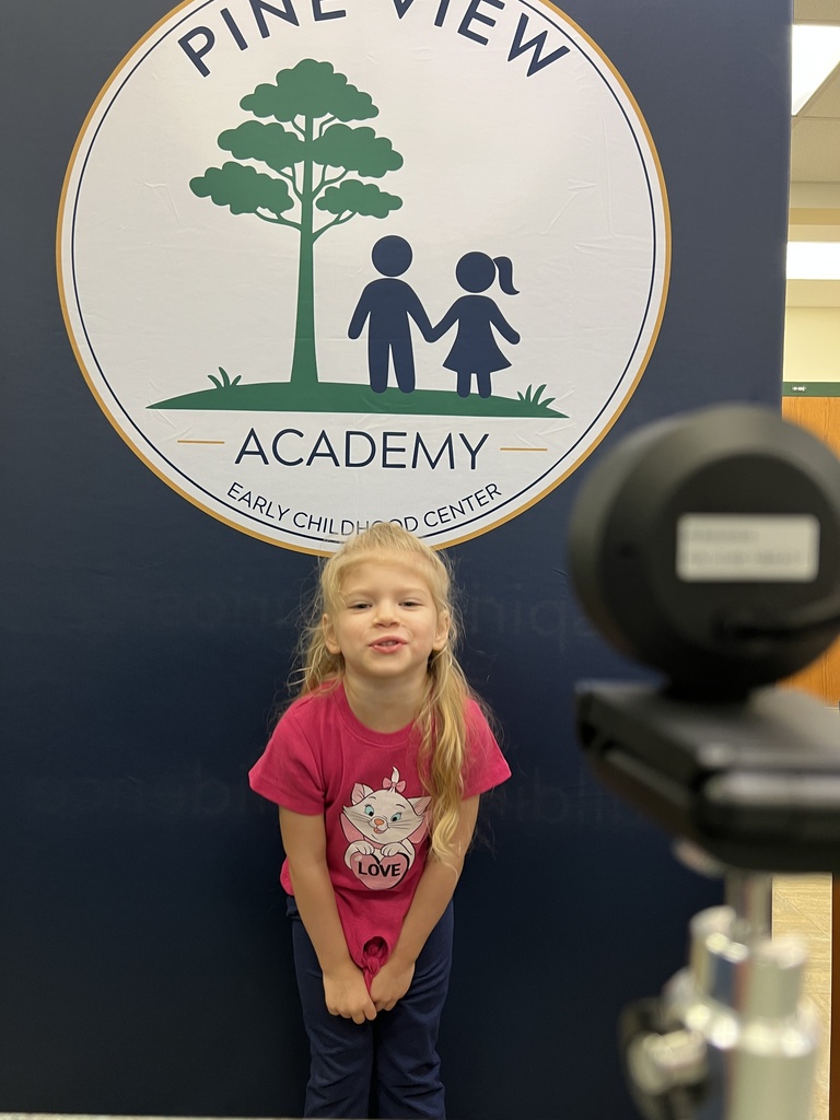 student smiling for student ID picture