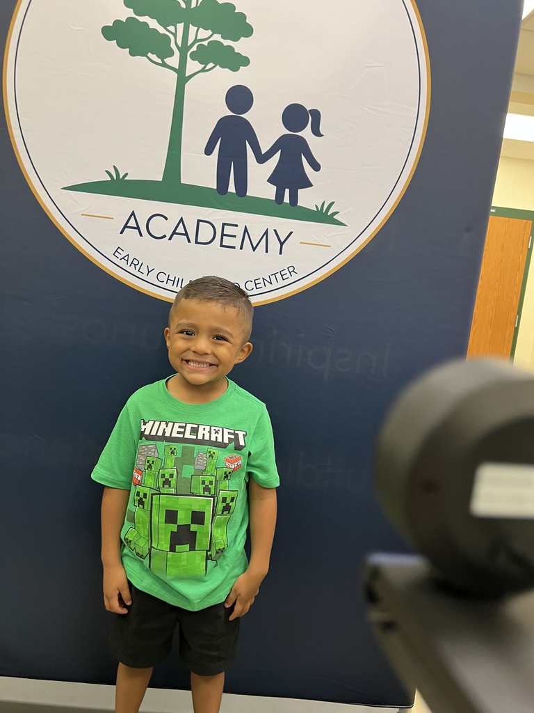 student smiling for student ID picture