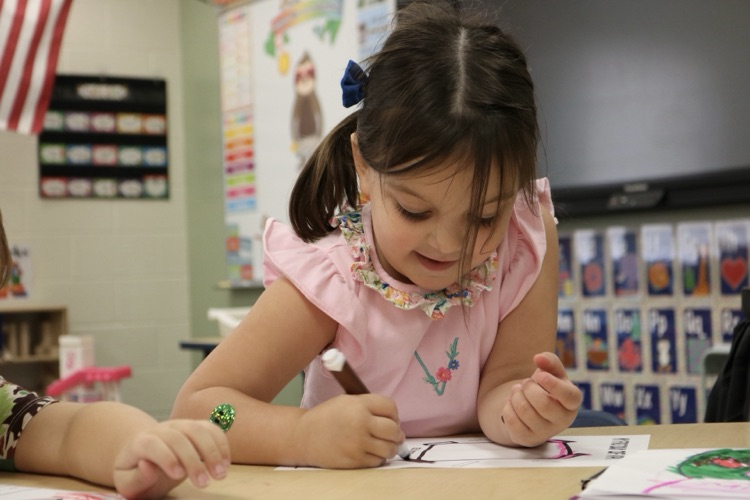student writing down 
