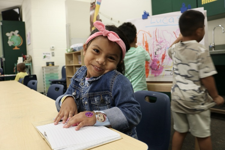 student smiling on desk