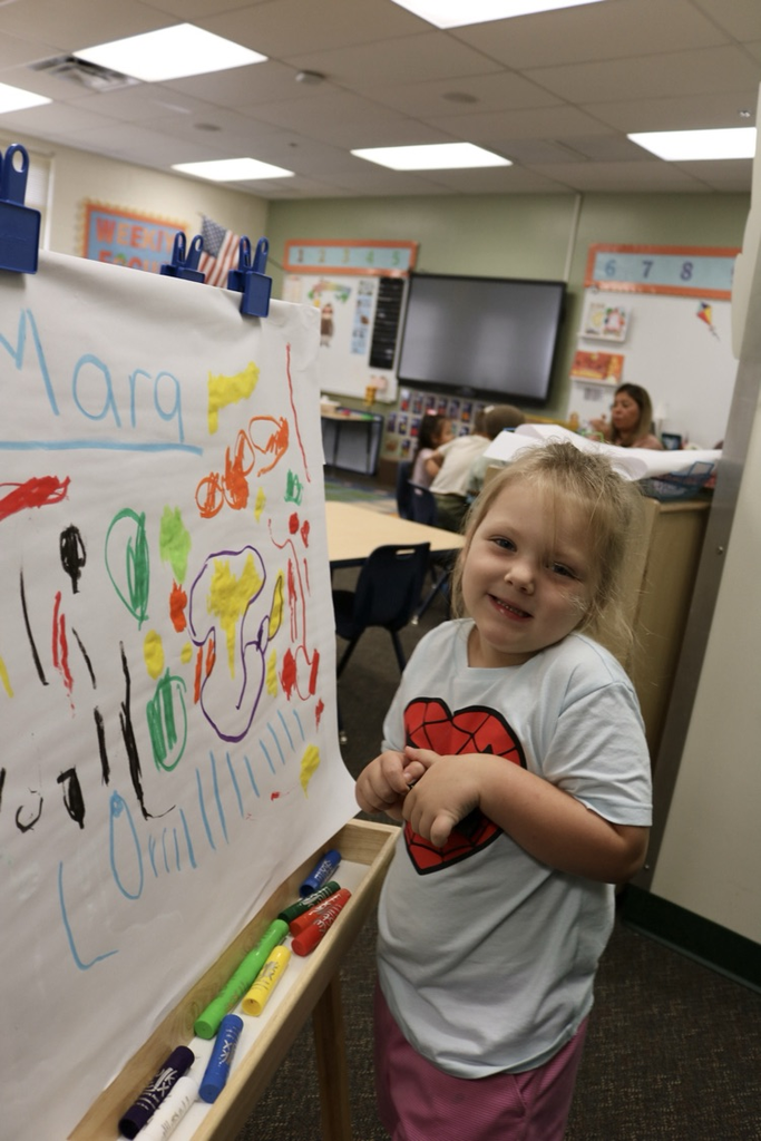  student smiling by artwork