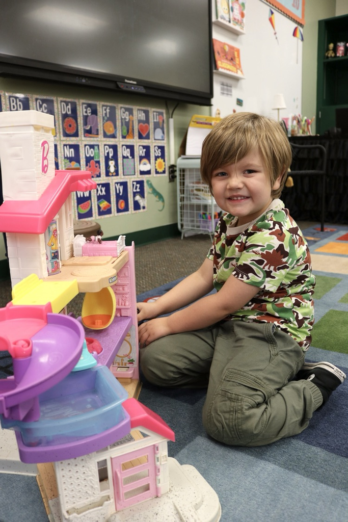 student playing with dollhouse