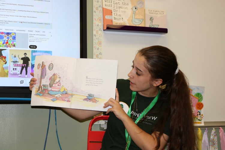 teacher reading outloud to students