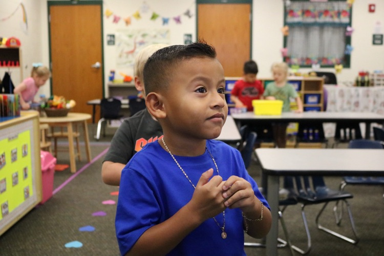 student smiling in his vpk class