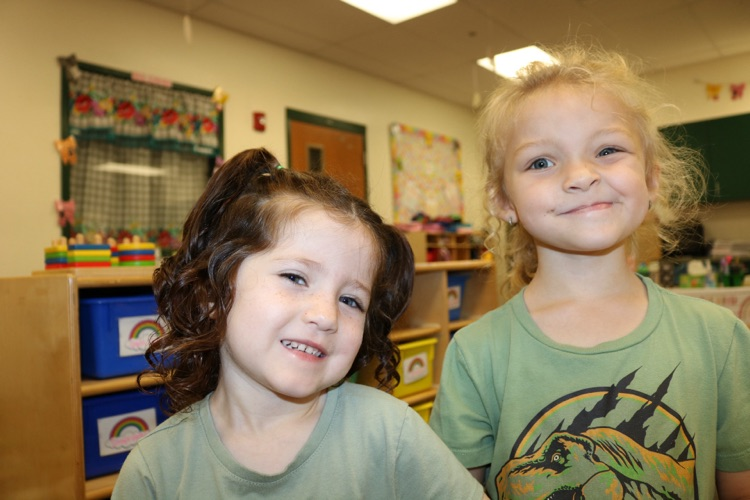 two prek students smiling in class