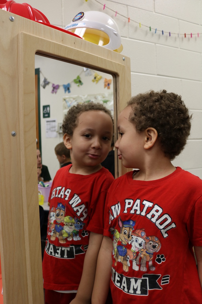 student playing by mirror