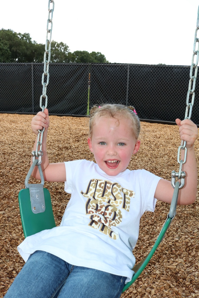 student smiling on swing