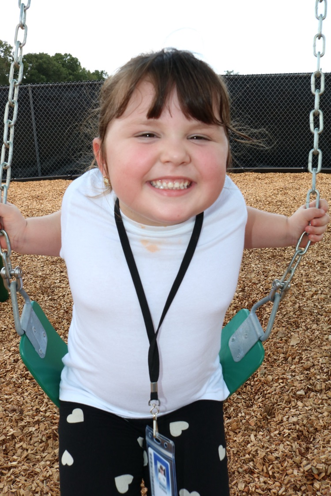 student smiling on swing