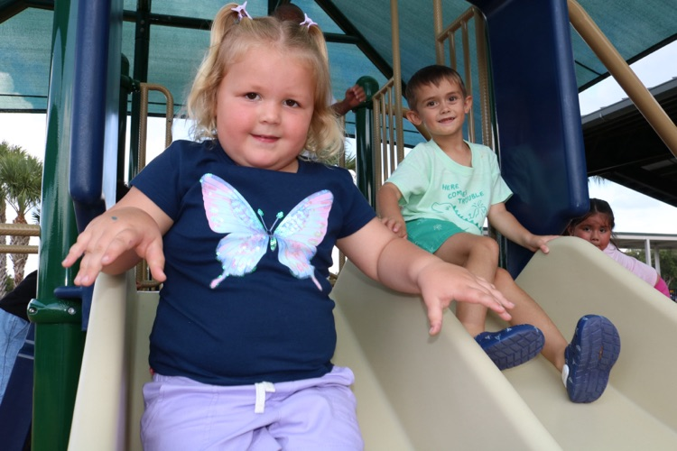 students smiling on slide