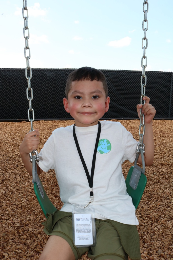 student smiling on swing
