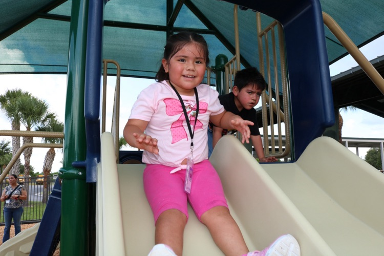 student smiling on swing