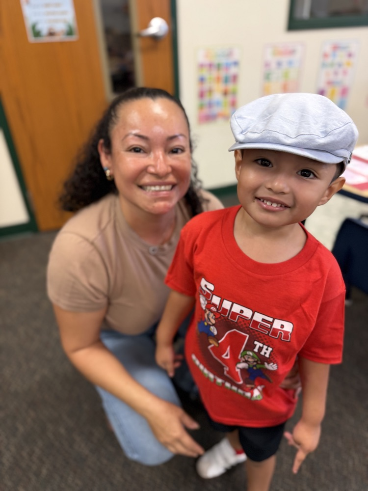 mom and student inside classroom smiling