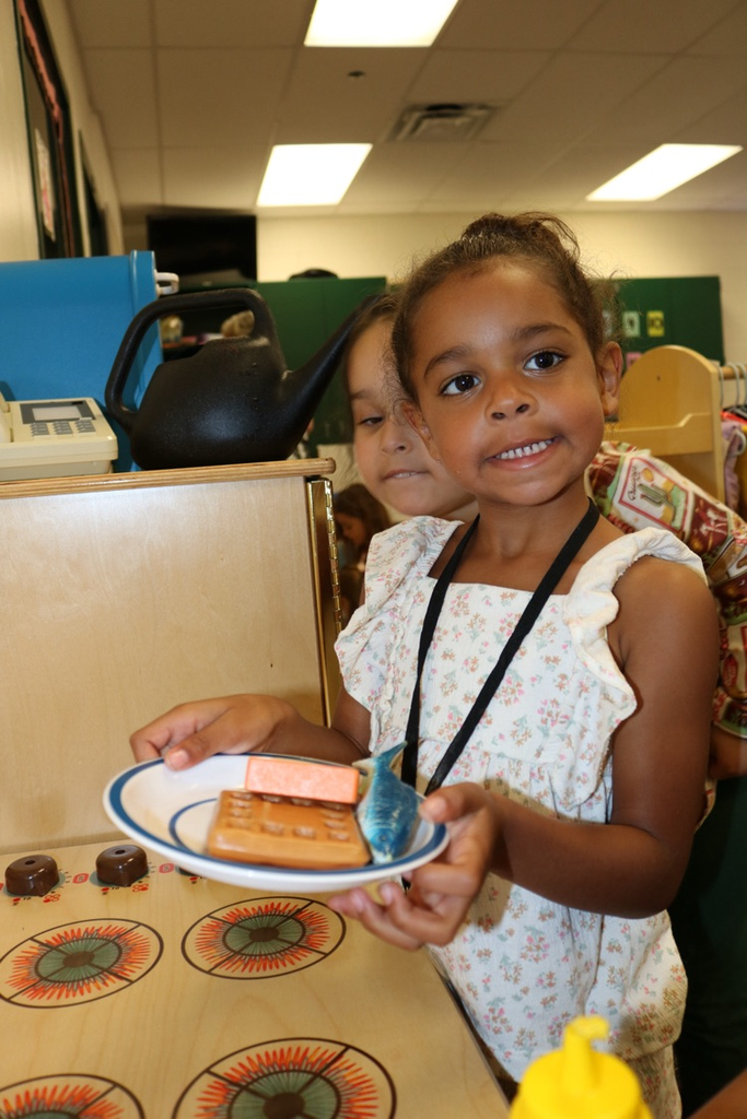 student playing with toy food