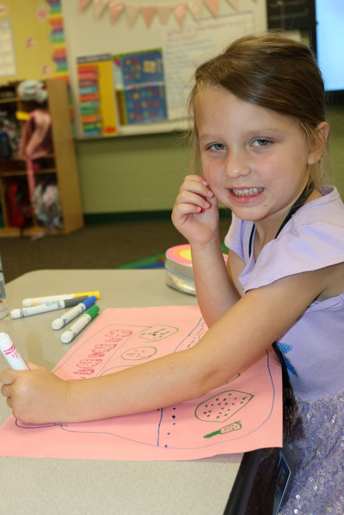 student drawing and smiling 