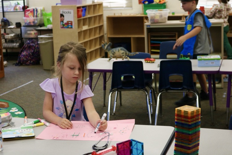 student drawing sitting in table 