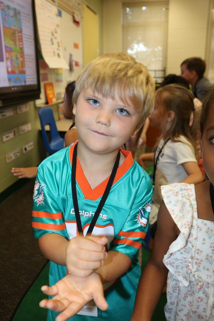 student playing with his hands in class