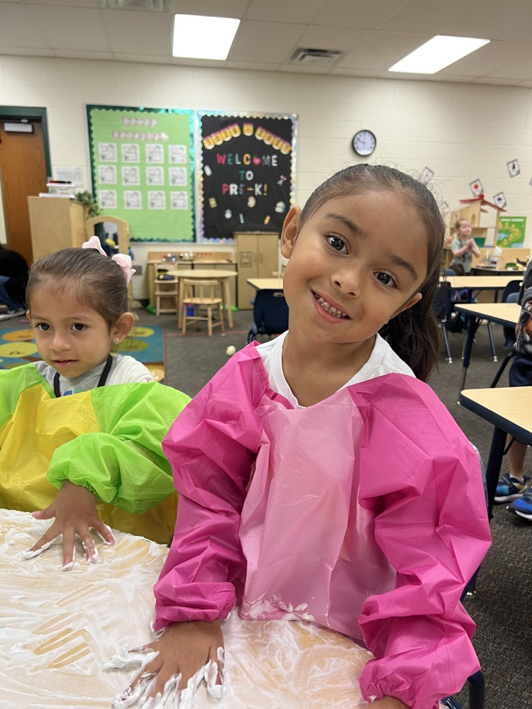 students smiling playing with foam 