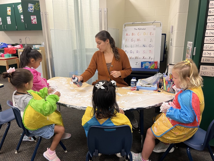 students playing with foam with teacher