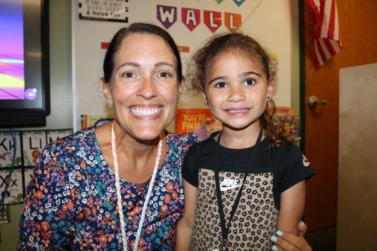student and teacher smiling