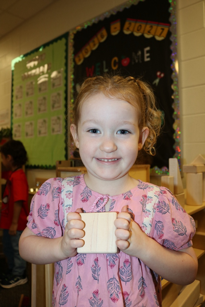 student smiling showing block