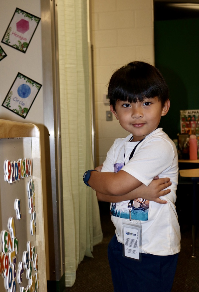 student striking a pose in prek class
