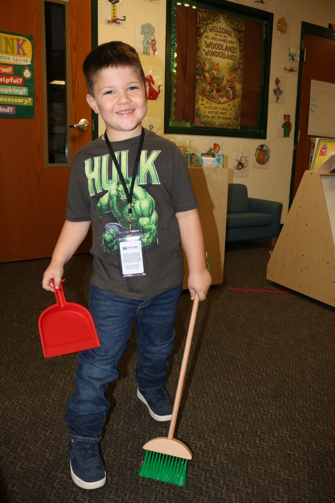 student pretending to sweep 