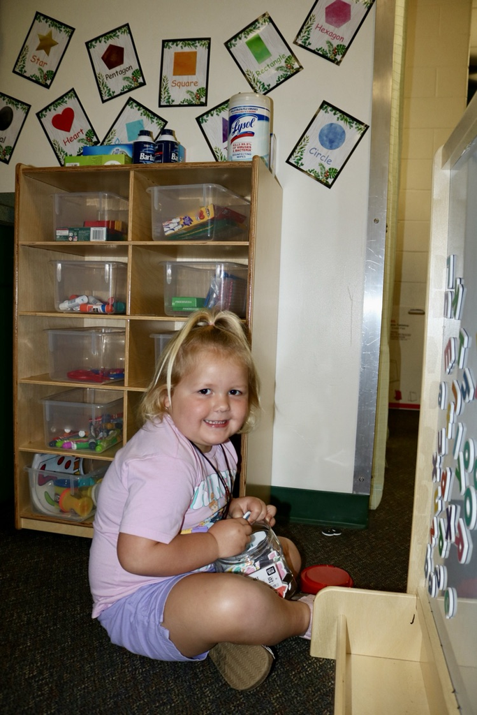 student on floor of classroom