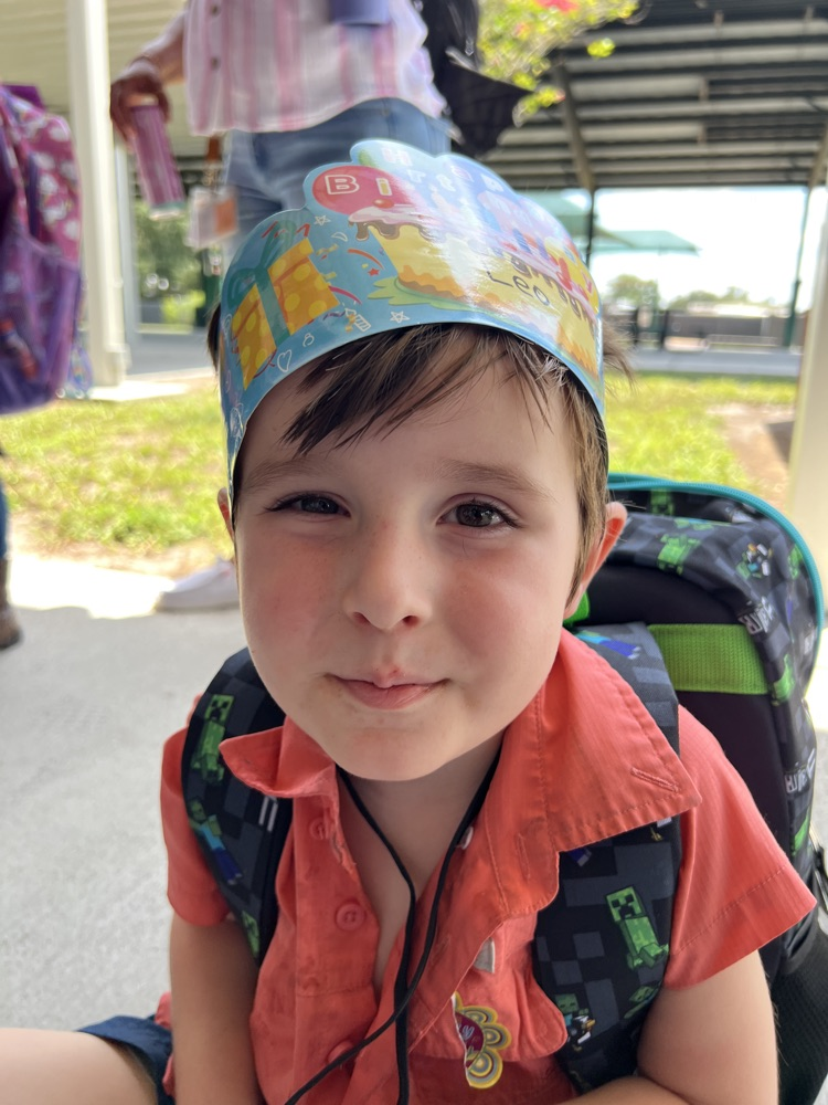 student wearing happy birthday crown
