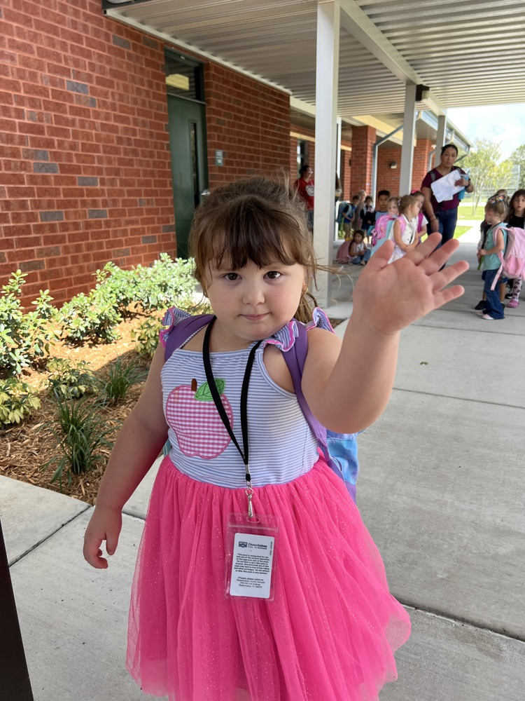 student waving goodbye at pick up