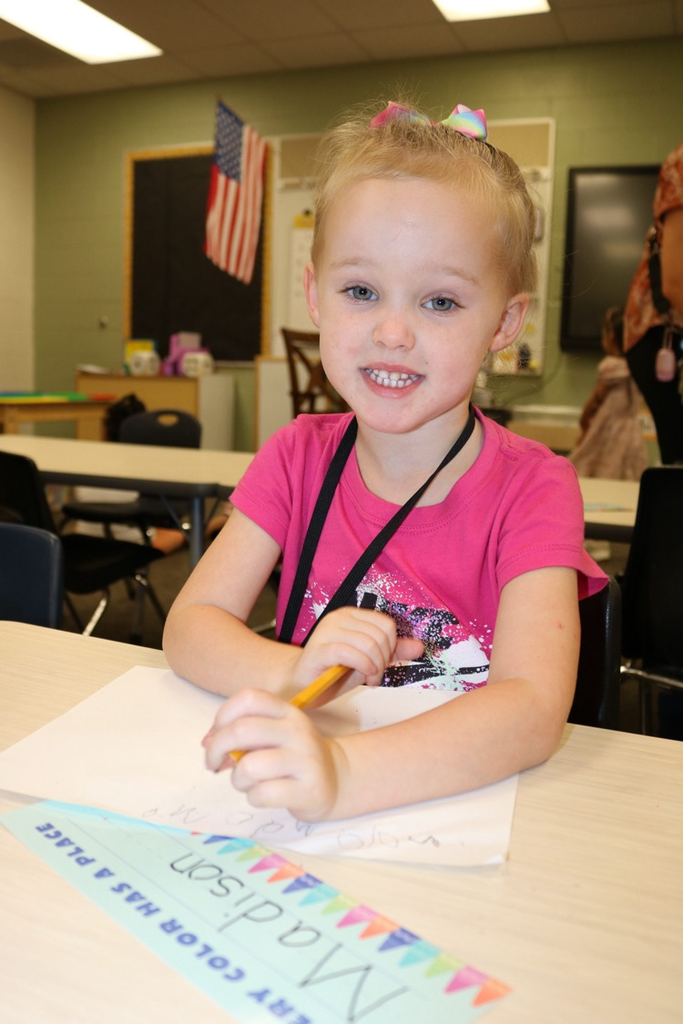 student writing in her prek class 