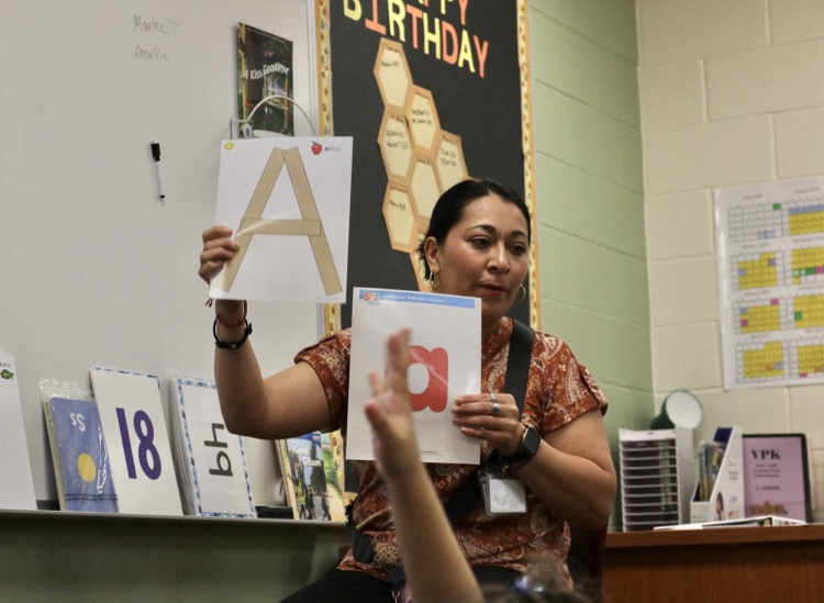 teacher showing the letter A