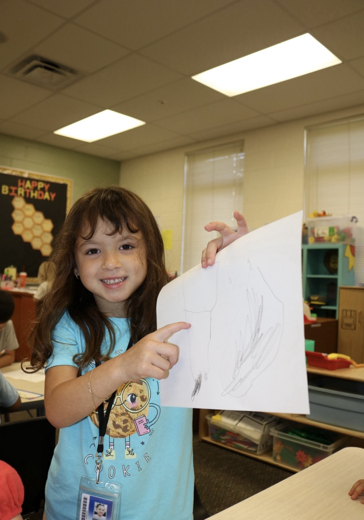 student showing her drawing 
